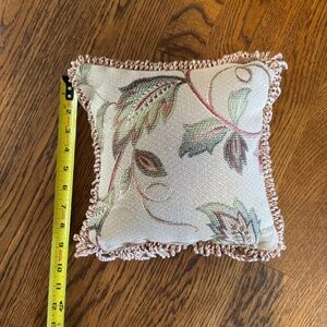 Vintage-style tapestry throw pillow with fringe trim